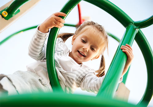 Girl playing on jungle gym