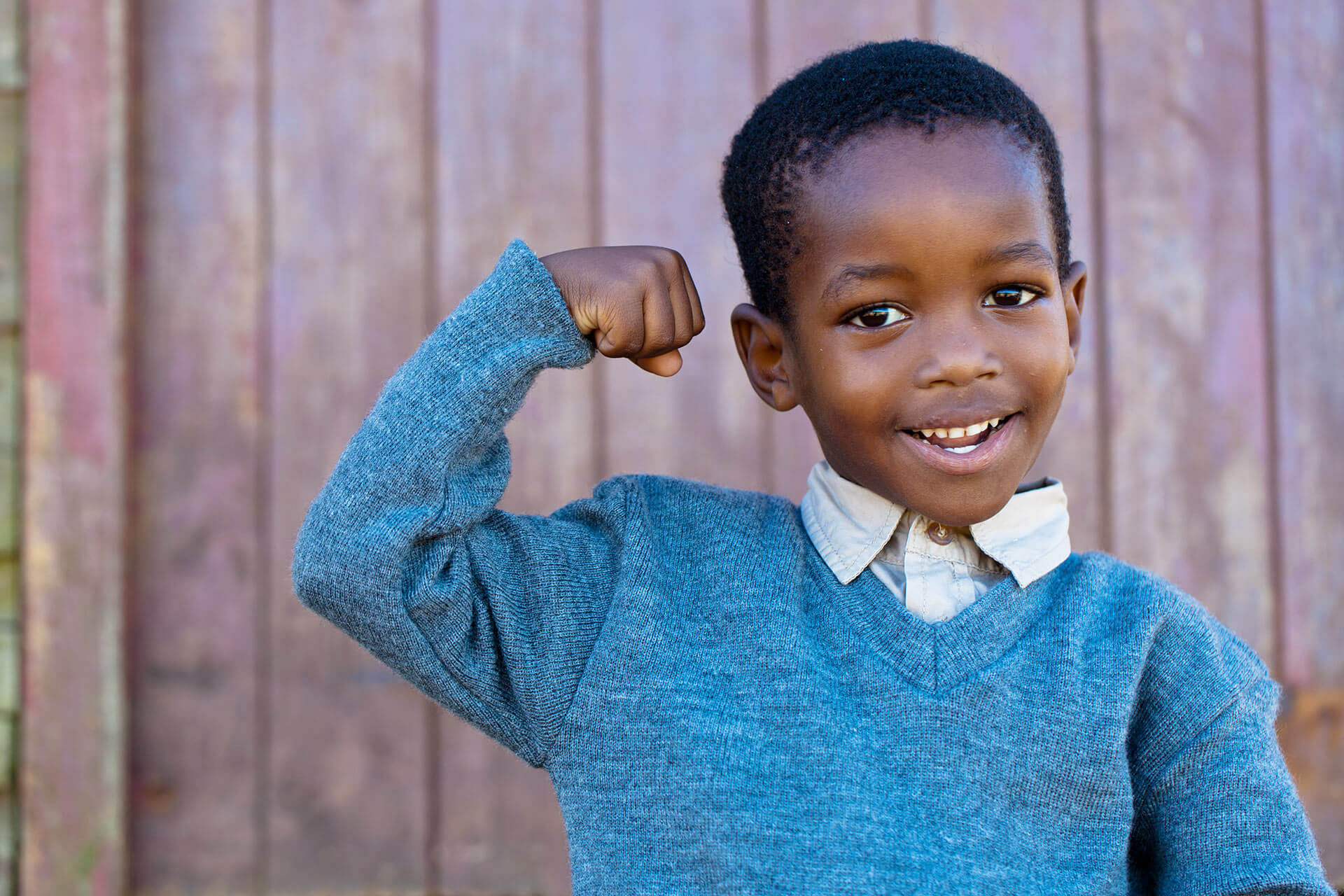 Boy making muscle